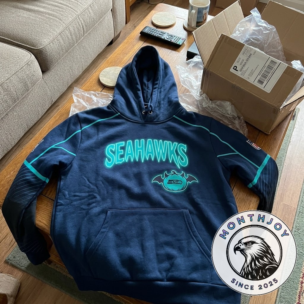 Seattle Seahawks hoodie front showing cyan lettering and Halloween bat graphic